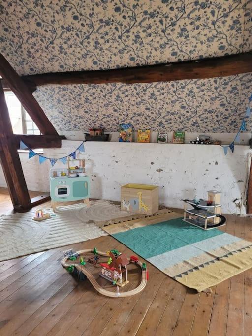 an attic room with a toy boat on the floor at L&#39;Echappée d&#39;Aristide - proche Giverny &amp; 50 min Paris in Houlbec-Cocherel
