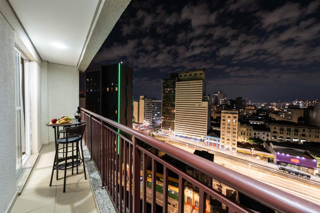 a balcony with a view of a city at night at Rover 1011 Centro in Sao Paulo
