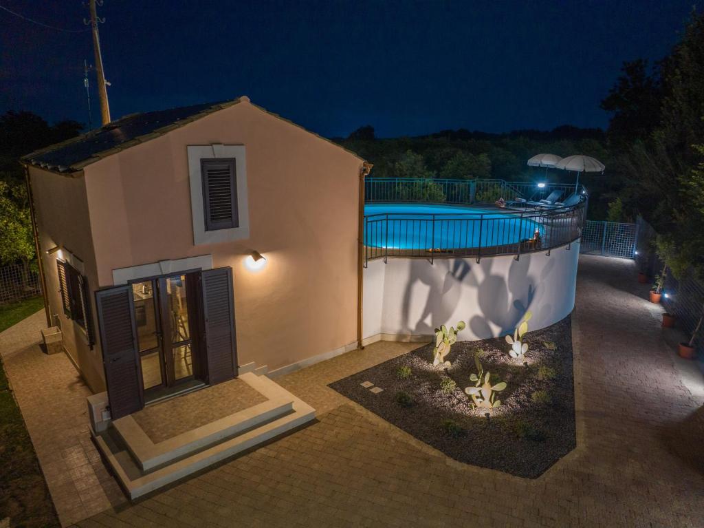 a house with a swimming pool at night at Villa Tatai Country House by Dimore Trinacria in Belvedere