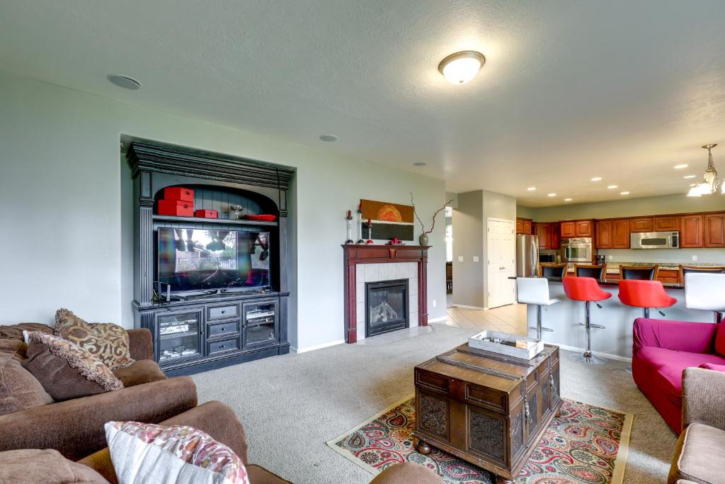 a living room with a tv and a fireplace at Spacious Vacation Rental Near Utah Lake! in Lehi