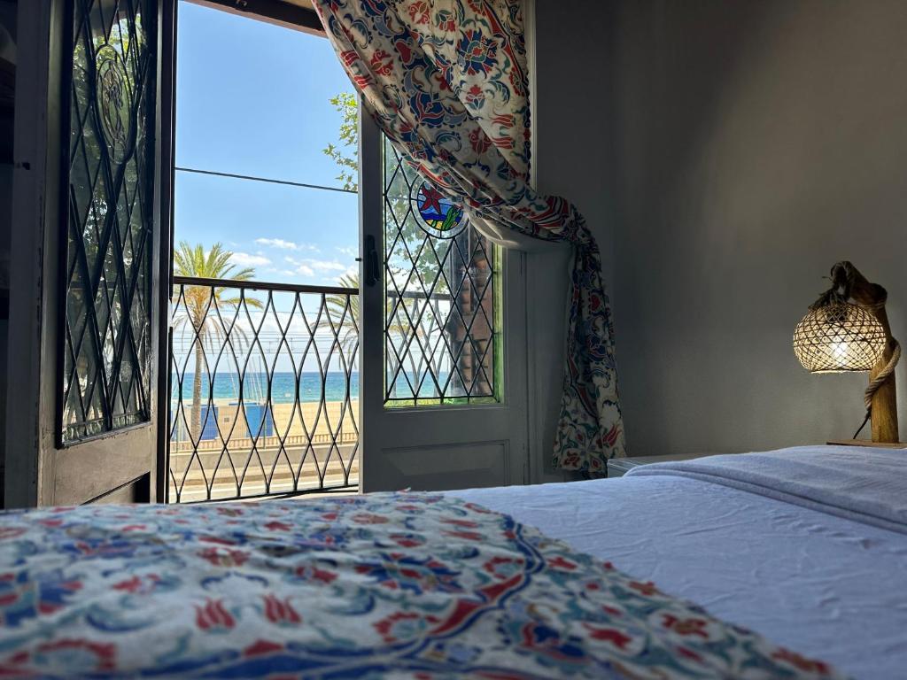 a bedroom with a bed and a view of the ocean at Vilador Beach Hotel in Masnou
