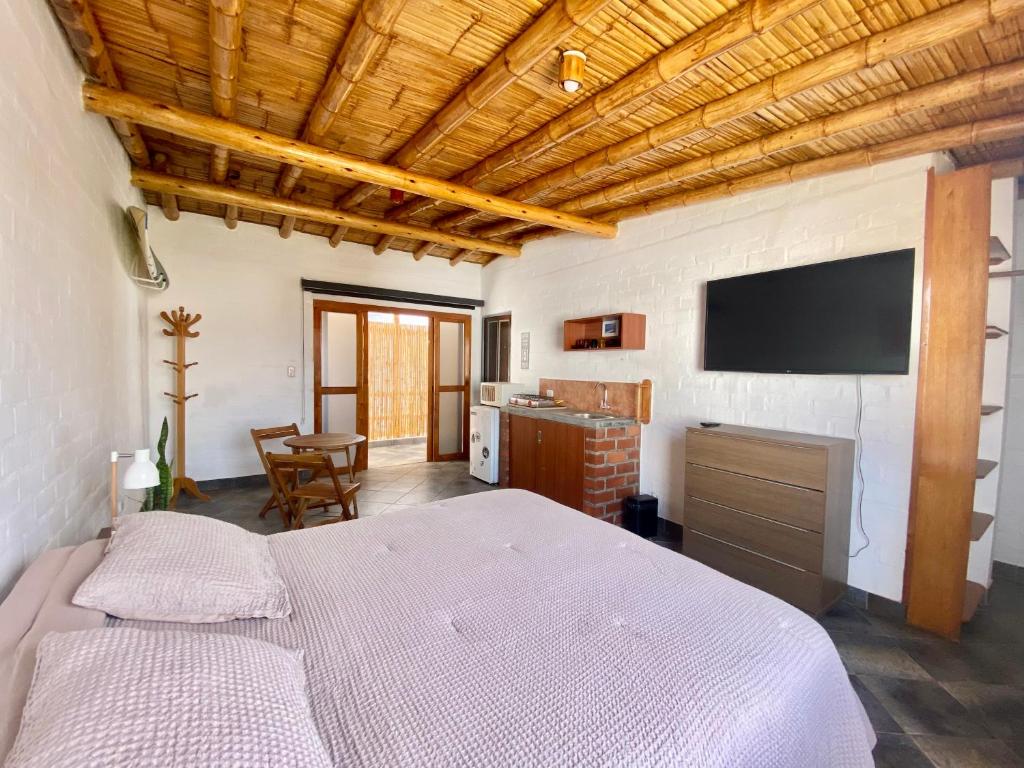 a bedroom with a bed and a flat screen tv at Casa Danda Punta Hermosa in Punta Hermosa