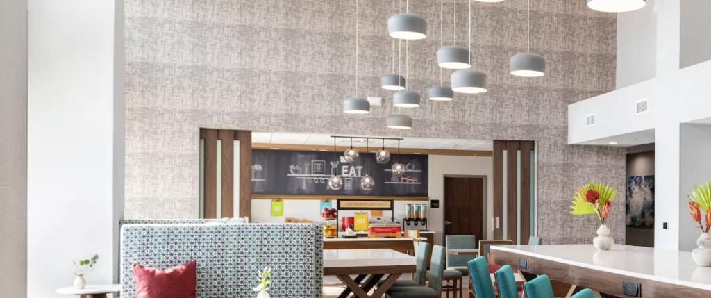 a dining room with a table and chairs at Hampton Inn Fort Myers Downtown in Fort Myers