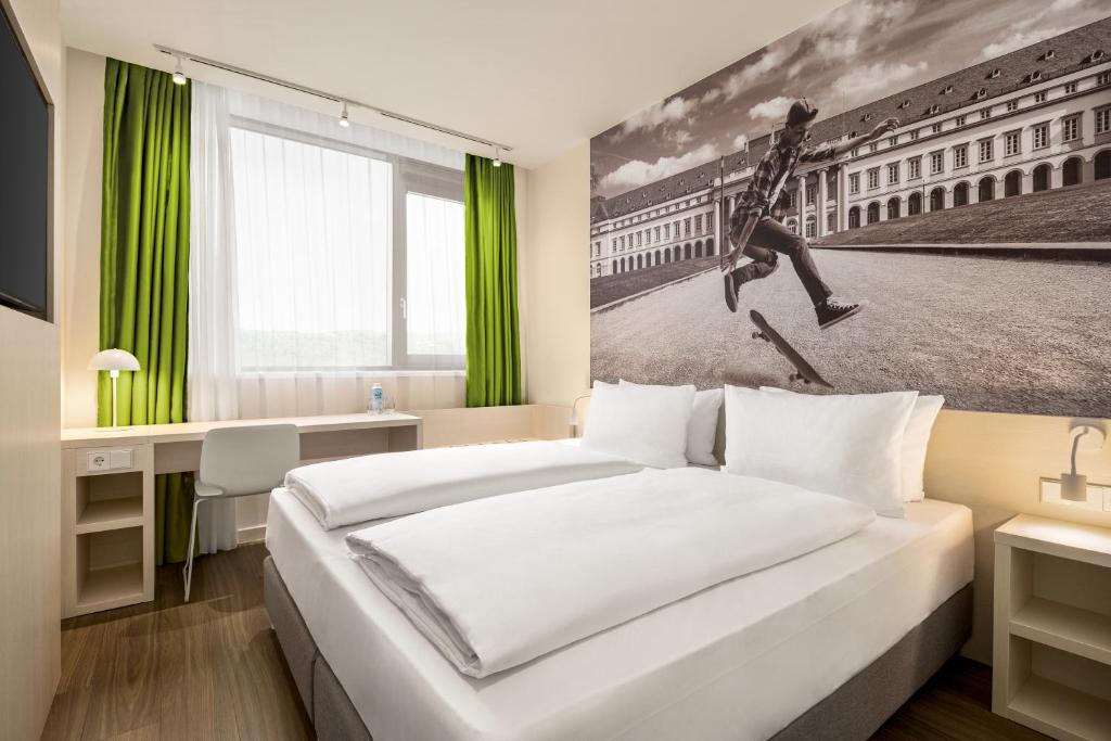 a hotel room with a bed and a picture of a person jumping at Super 8 by Wyndham Koblenz in Koblenz