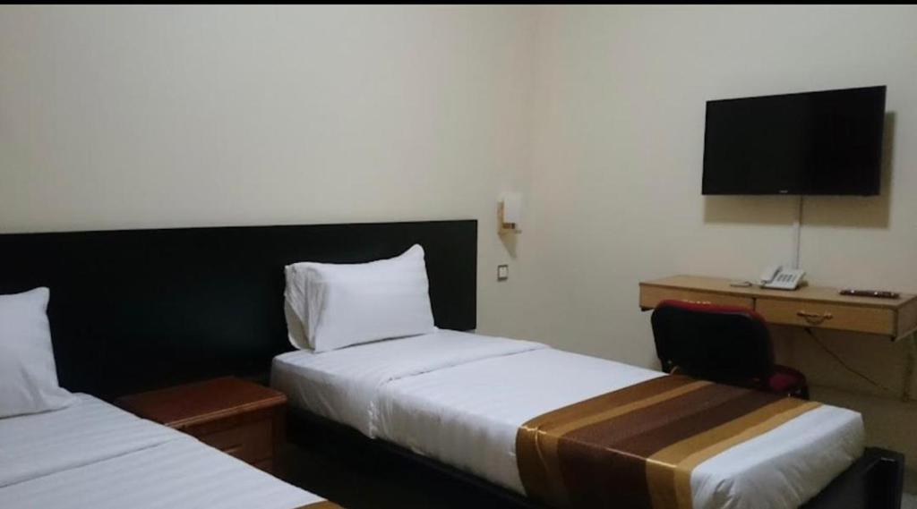 Postel nebo postele na pokoji v ubytování Ubuntu Palace Hotel Kampala