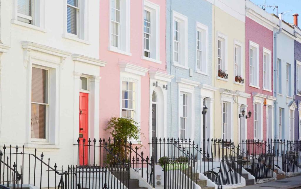 a row of brightly colored houses on a street at Notting Hill Residences in London