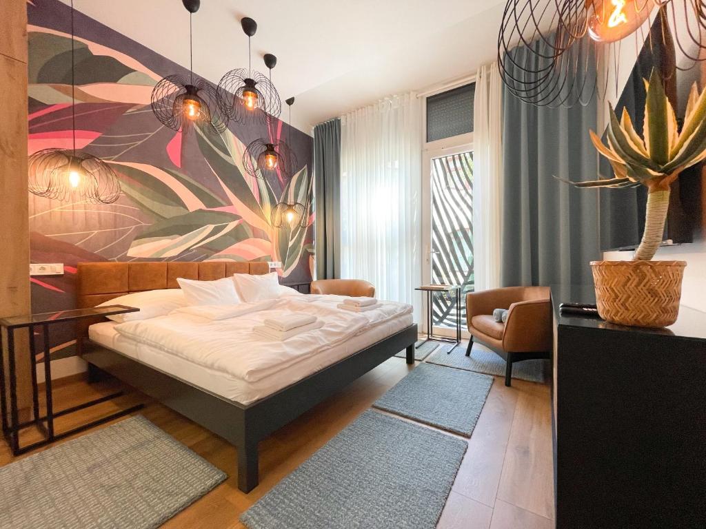 a bedroom with a bed and a painting on the wall at Botaniq Room in Gyula