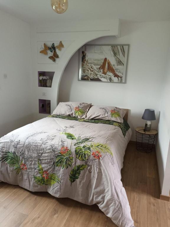 a bedroom with a bed with plants on it at le 18 avenue du côteau 2/3 personnes tout confort in Charmes