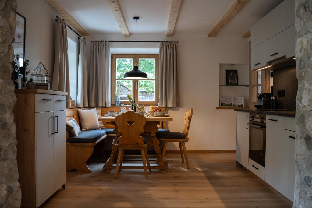 een keuken en een woonkamer met een tafel en stoelen bij Neu! Ferienhaus Moritz & Josie (zur Alleinnutzung) / Eröffnung 01. Juli 2023 in Ohlstadt