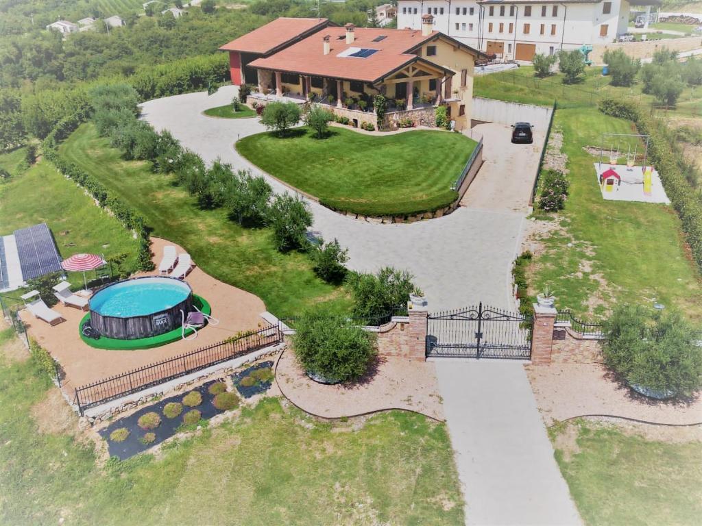 an aerial view of a house with a swimming pool at La Collina dei Ciliegi in San Mauro di Saline