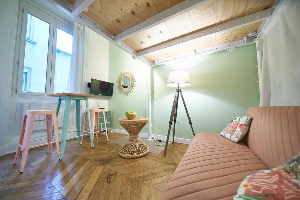 a living room with a couch and a table at Studio cosy Valmy- Vaise-Lyon centre in Lyon