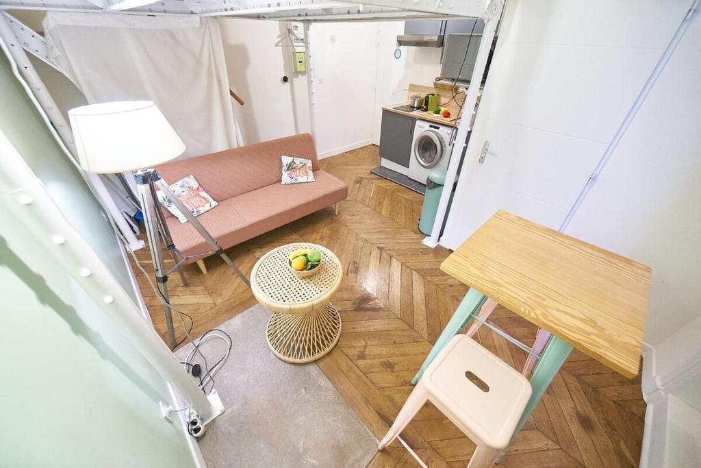 a small living room with a couch and a table at Studio cosy Valmy- Vaise-Lyon centre in Lyon
