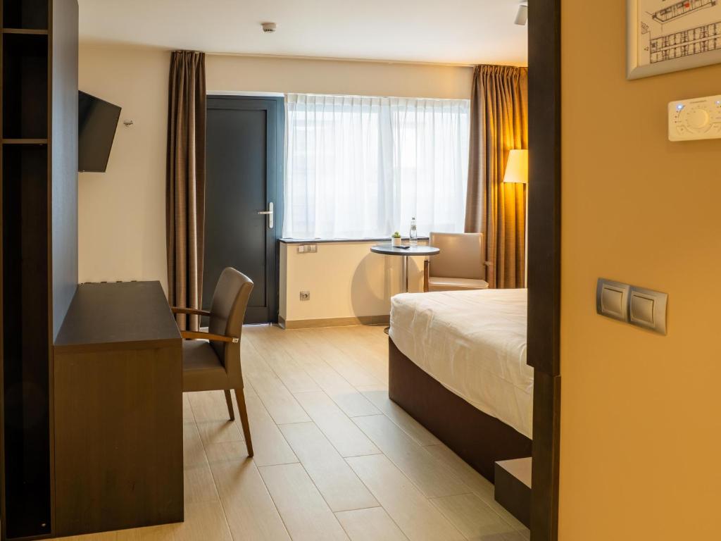 Postel nebo postele na pokoji v ubytování Tower Hotel Aalst
