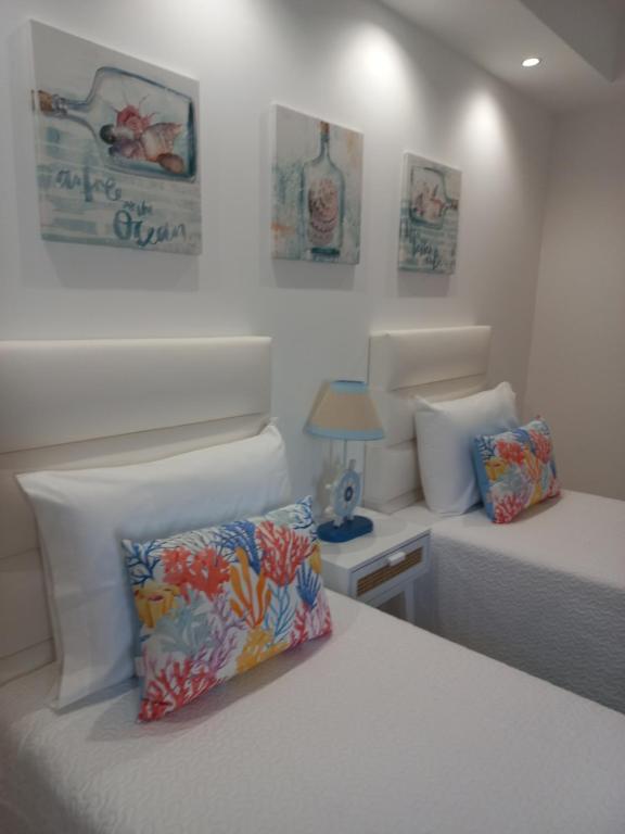 a bedroom with two beds and a pillow on a bed at Helena's House in Nazaré