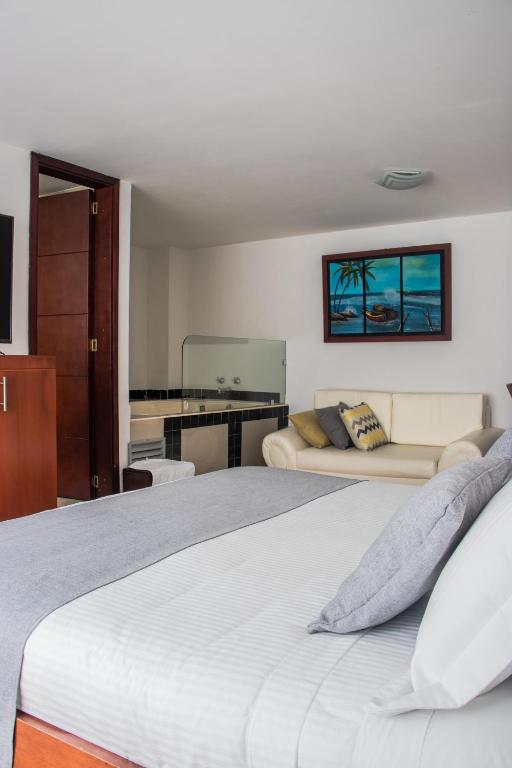 Postel nebo postele na pokoji v ubytování Nogal Suite Hotel Pasto