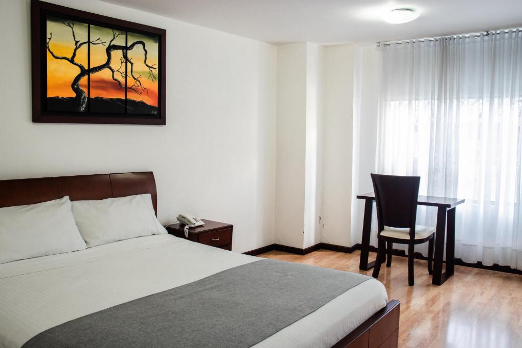 Postel nebo postele na pokoji v ubytování Nogal Suite Hotel Pasto