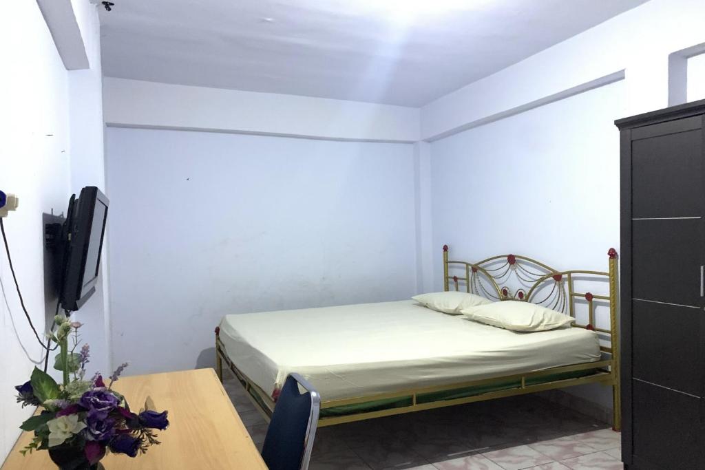 Katil atau katil-katil dalam bilik di OYO 92892 Aini Homestay