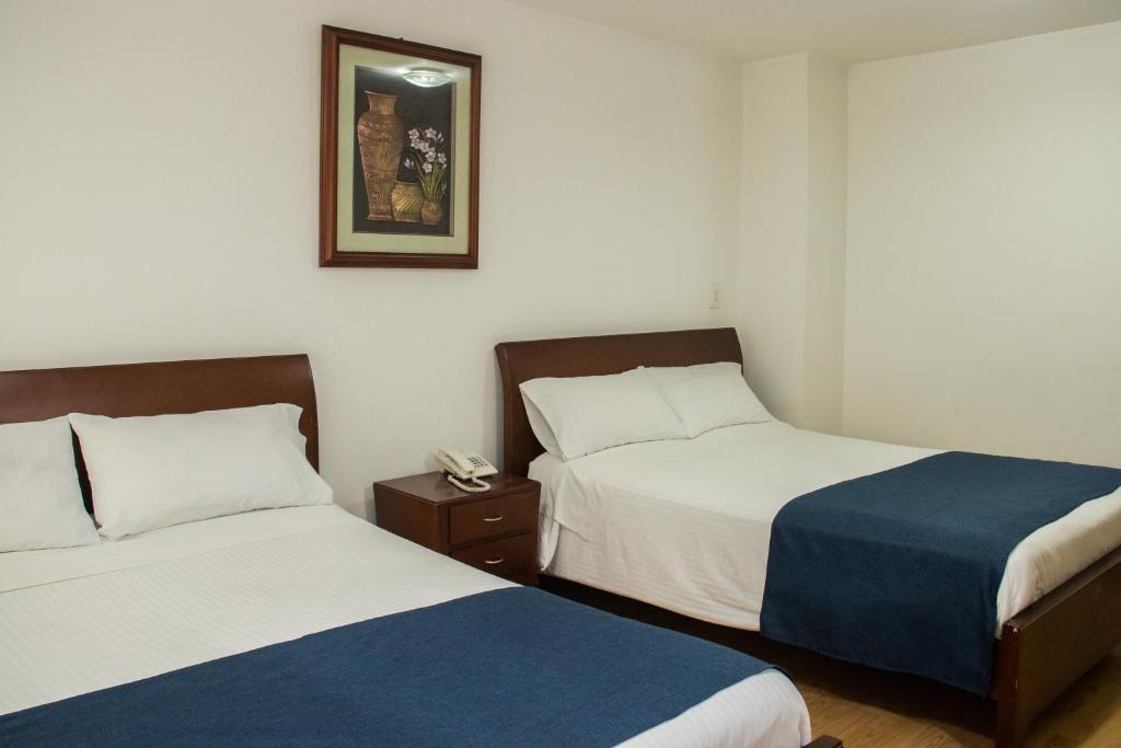 Postel nebo postele na pokoji v ubytování Nogal Suite Hotel Pasto