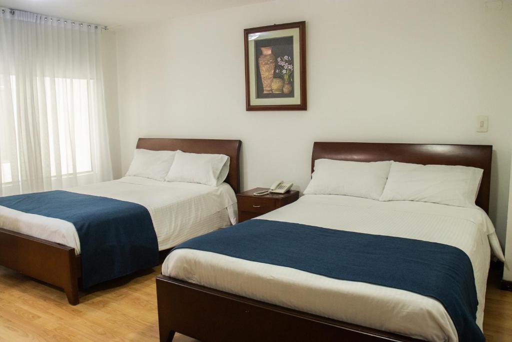 Postel nebo postele na pokoji v ubytování Nogal Suite Hotel Pasto