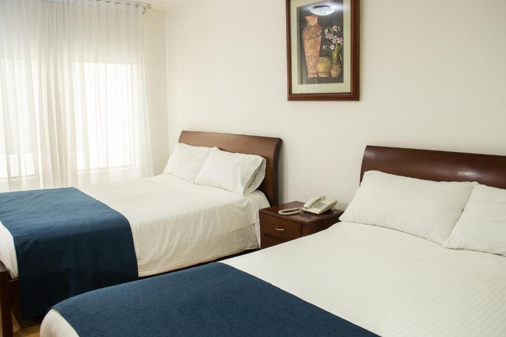 Postel nebo postele na pokoji v ubytování Nogal Suite Hotel Pasto