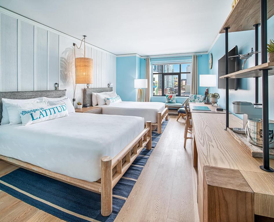 two beds in a room with blue walls at Margaritaville Hotel San Diego Gaslamp Quarter in San Diego