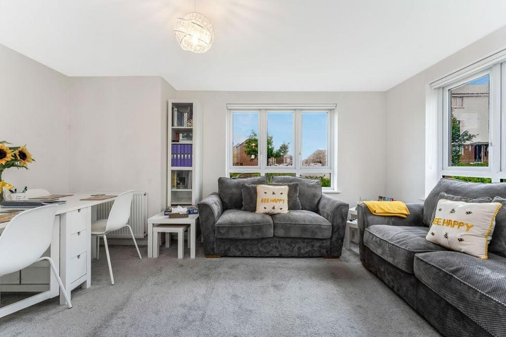 a living room with a couch and a table at GuestReady - The Beehive in Edinburgh in Edinburgh