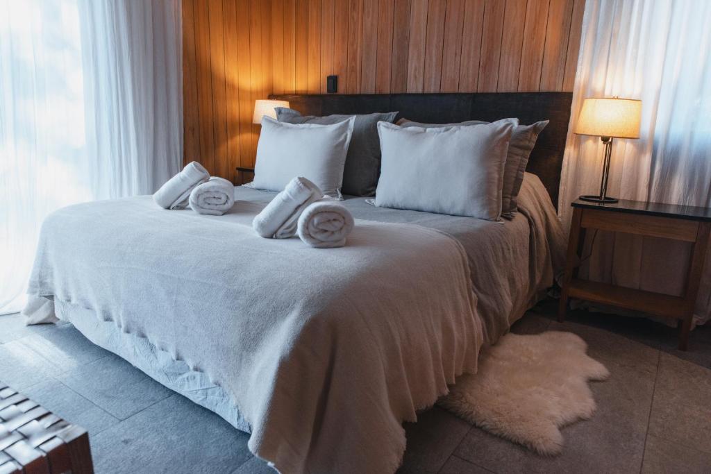 ein Schlafzimmer mit einem großen Bett mit Handtüchern darauf in der Unterkunft Vilas de Montaña in San Martín de los Andes