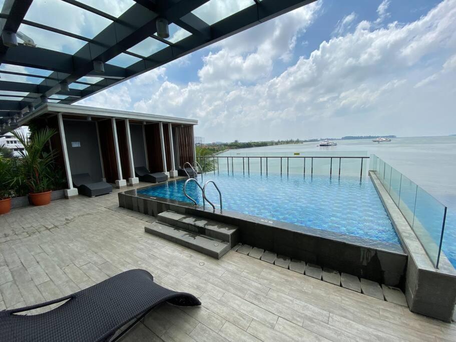 a swimming pool with a view of the water at Peaceful Sea view Cozy APT at Batam Center - By MESA in Batam Center
