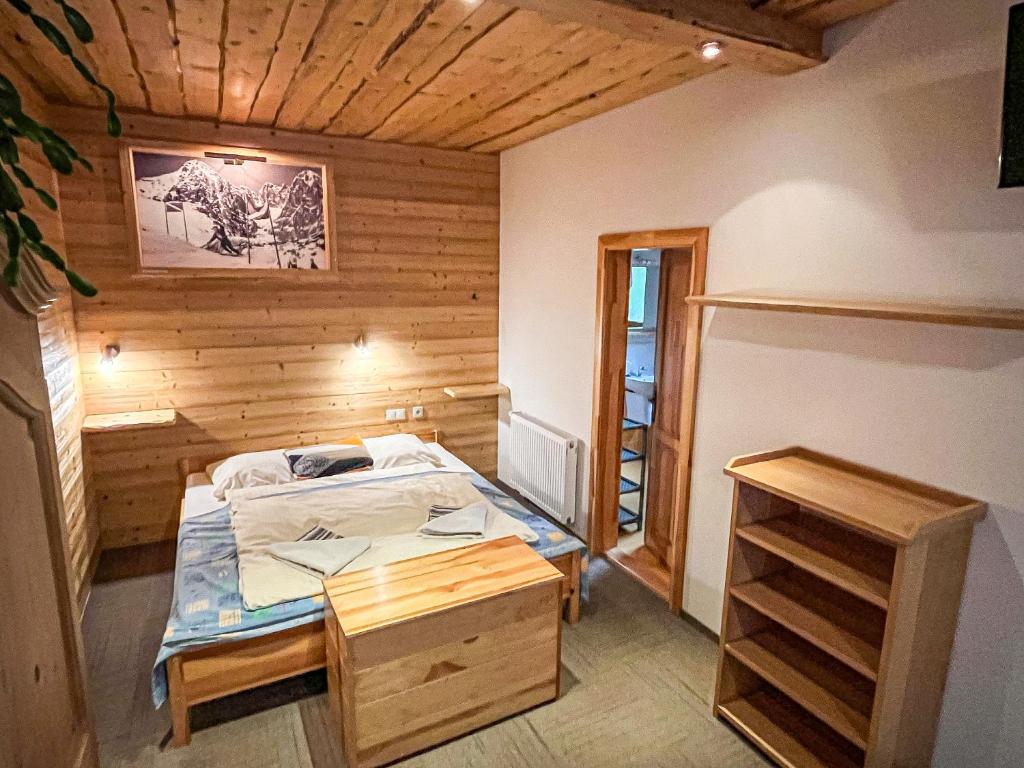 A bed or beds in a room at Apartmány Limba
