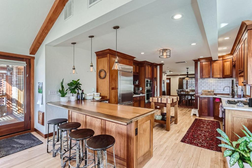 a kitchen with wooden cabinets and bar stools at 343 S Gilpin St in Denver