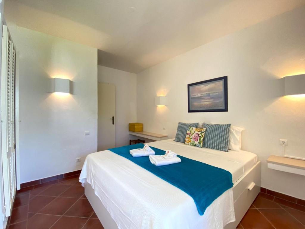 a bedroom with a bed with two towels on it at Albufeira Quinta da Balaia Garden by Homing in Albufeira