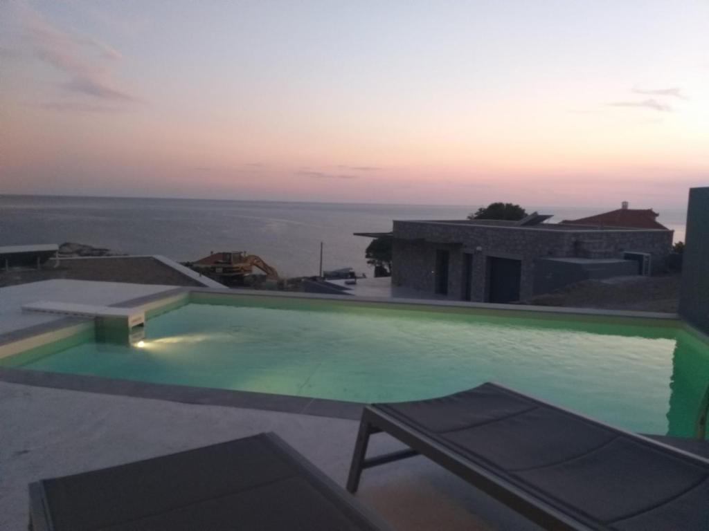 a swimming pool on the roof of a house at Villa la Vago in Agios Ioannis Kaspaka