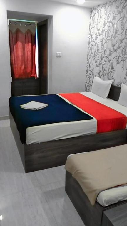 Postel nebo postele na pokoji v ubytování Hotel Gitanjali