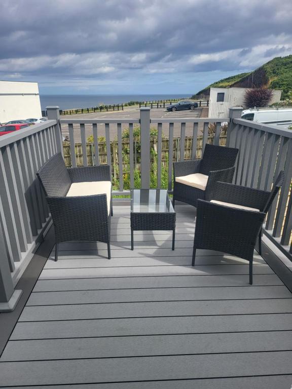 a group of chairs and tables on a balcony at Royal Court Hotel in Portrush