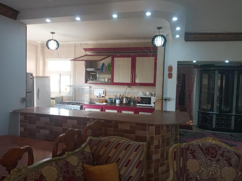 a kitchen with a brick island in the middle at جراند هاوس مدينتى in Madinaty