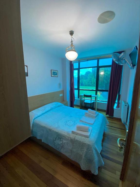 A bed or beds in a room at Hostal Pumar
