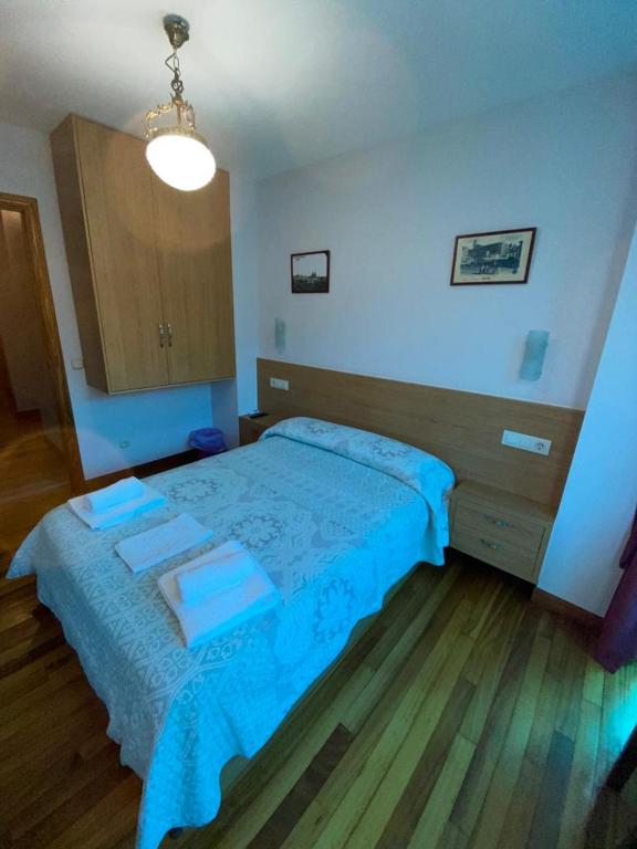 A bed or beds in a room at Hostal Pumar
