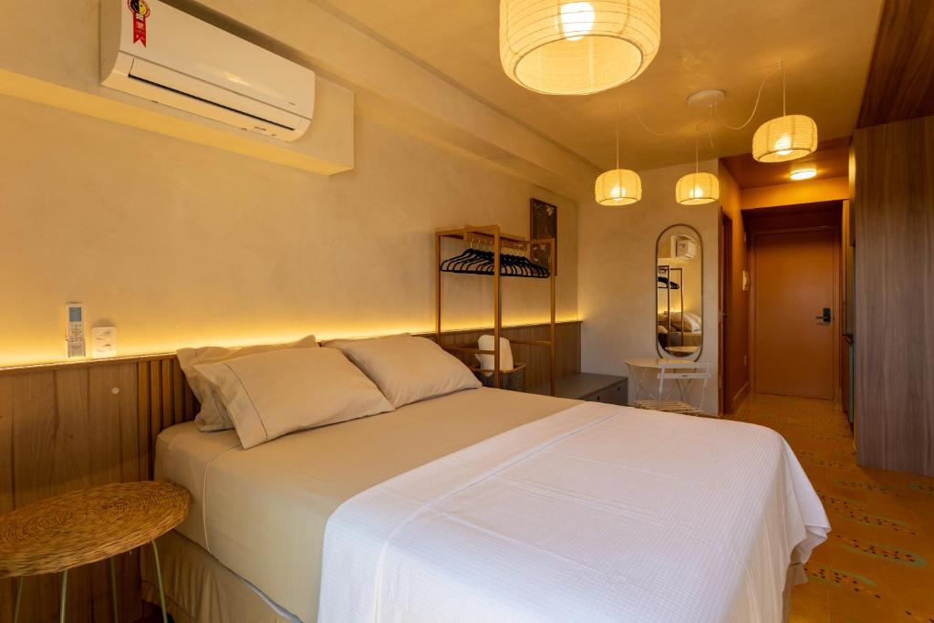 a bedroom with a large white bed in a room at Studio Savana in São Paulo