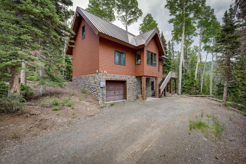 a house on a dirt road in the woods at Cozy Beaver Retreat with Fireplace and Deck! in Beaver
