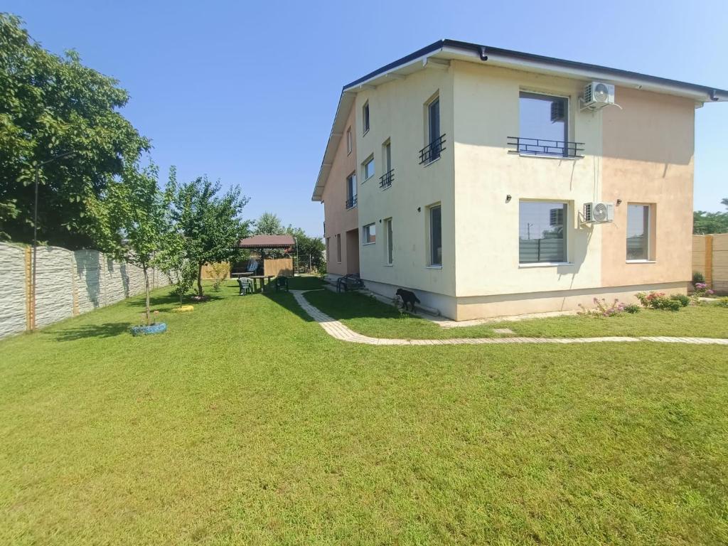 une image d'une maison avec une cour dans l'établissement Camera de la Bunici - o poarta catre oriunde, à Secuiu