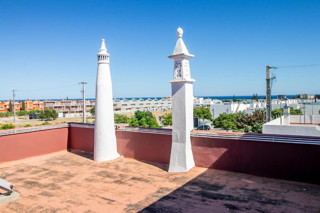 two white towers on the roof of a building at Tavira Balsa Romana - Luz de Tavira in Luz de Tavira