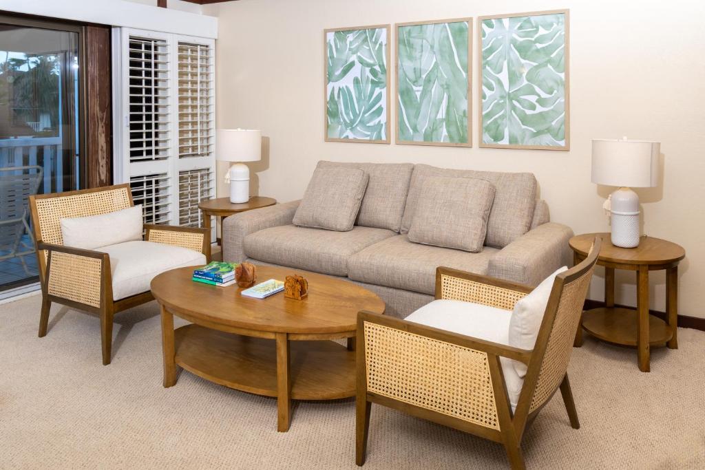a living room with a couch and chairs and a table at Luxury condo in Poipu in Koloa