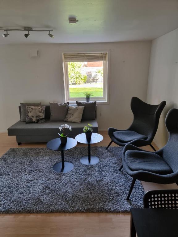 a living room with two chairs and a couch at Apartment 7 min from the airport in Bergen