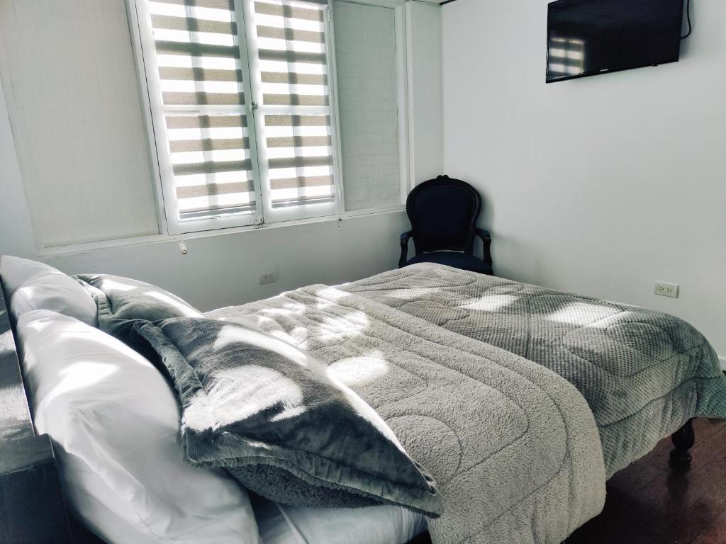 Postel nebo postele na pokoji v ubytování Hotel Muros Quito