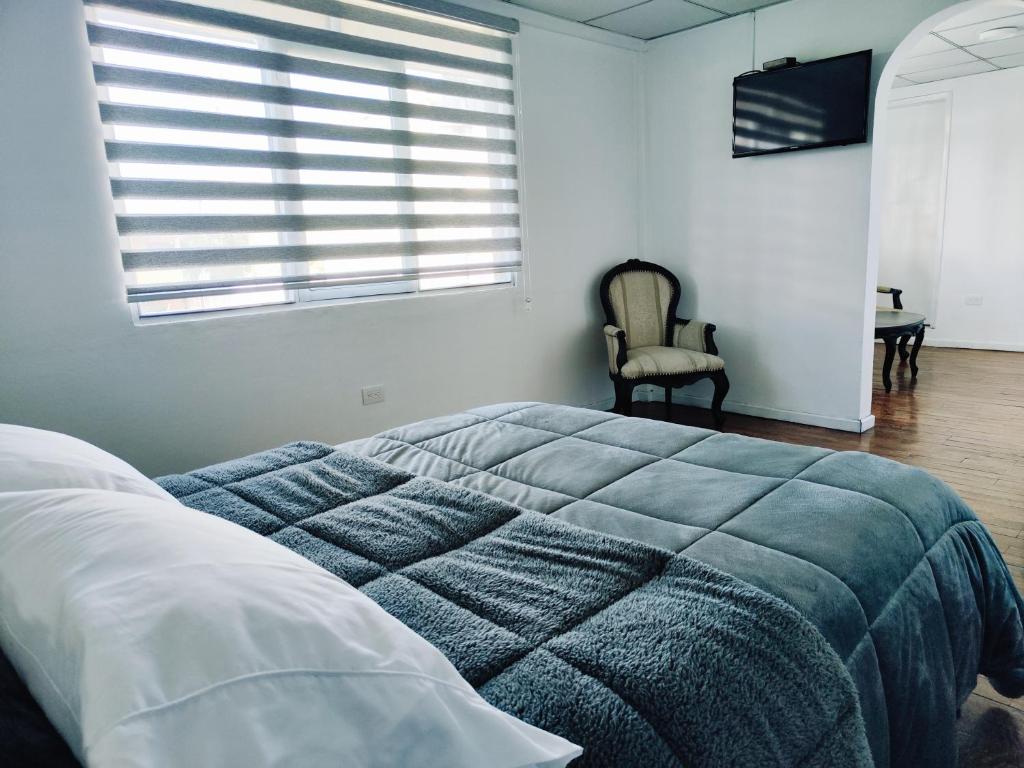 Postel nebo postele na pokoji v ubytování Hotel Muros Quito