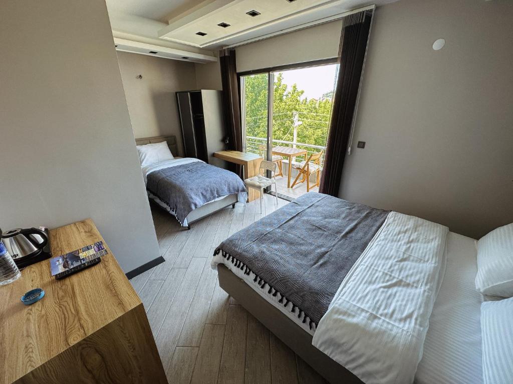 a hotel room with two beds and a window at Hostel Amasra in Bartın