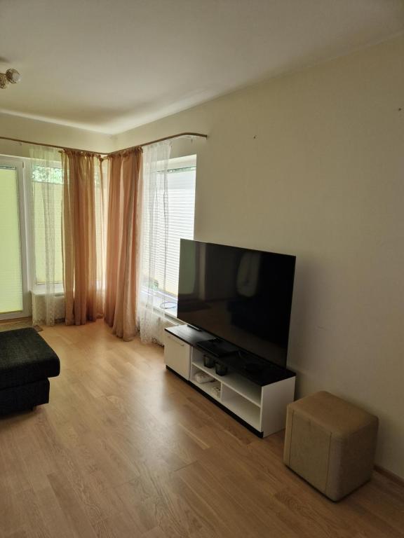 a living room with a large flat screen tv at Padriku Apartment with a balcony,near to central,Self Check In 24 7,FREE Parking in Tallinn