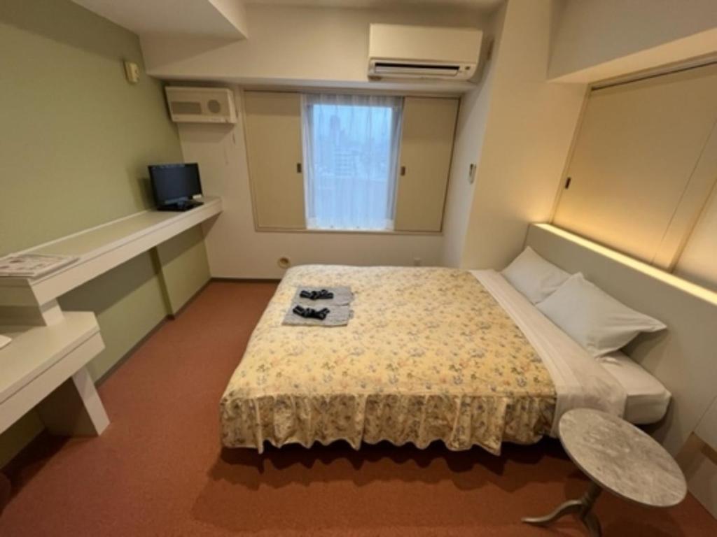 a small room with a bed and a window at Hotel Alpha Inn Akita - Vacation STAY 67273v in Akita
