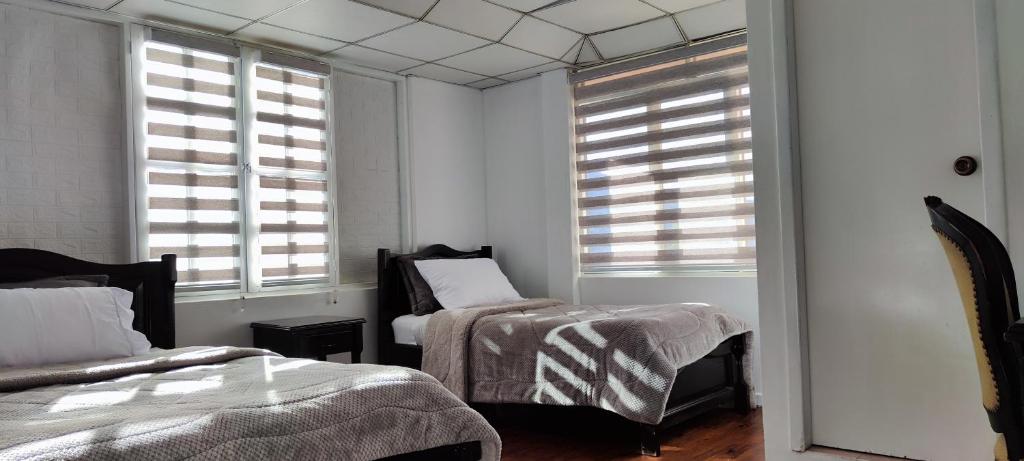 Postel nebo postele na pokoji v ubytování Hotel Muros Quito