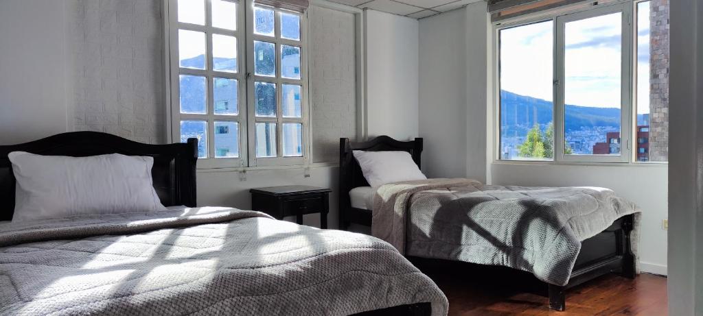 Postel nebo postele na pokoji v ubytování Hotel Muros Quito